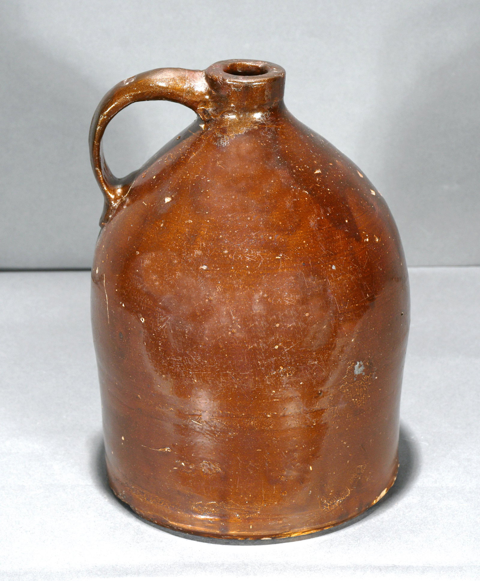 Anonymous Traditional Jug.: Anonymous. Traditional One Gallon Jug. Stamped on handle. Excellent condition. 10" h. Est. $300-500. Ship: $55