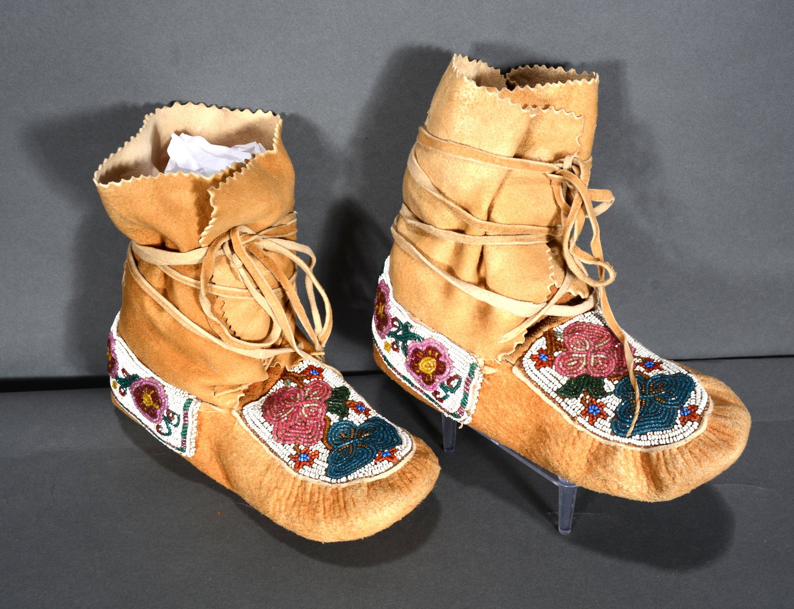 Pair of Moccasin Boots.: Pair of Moccasin Boots. Beaded leather. Unknown tribe. Excellent condition. 9" x 7". Est. $300-500. Ship: $35