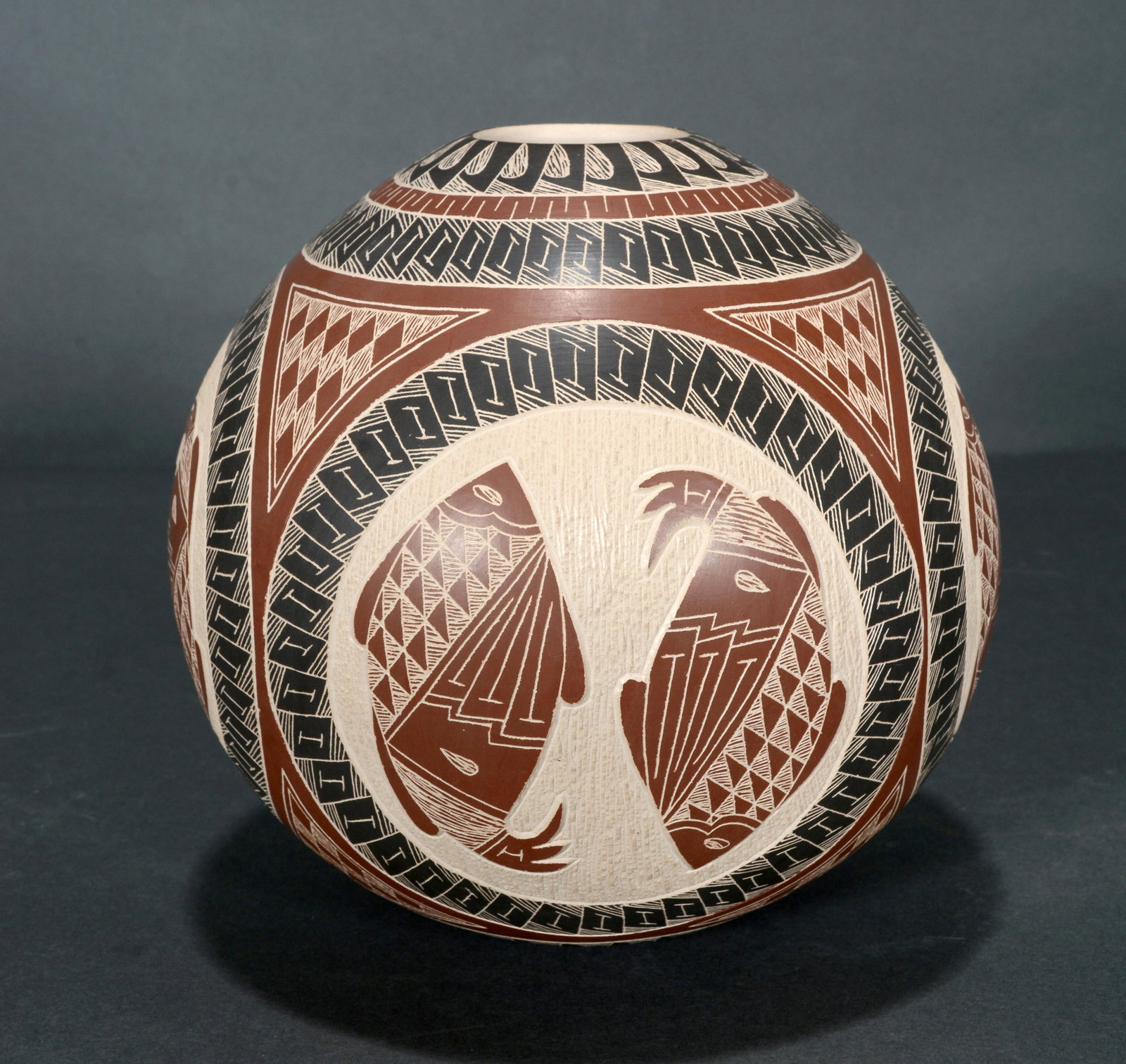 Aaron Flores. Fish Pot.: Aaron Flores. Fish Pot. Signed. Decorated and carved-relief pot. Mint condition. 6" h x 6" diameter. Est. $200-300. Ship: $45