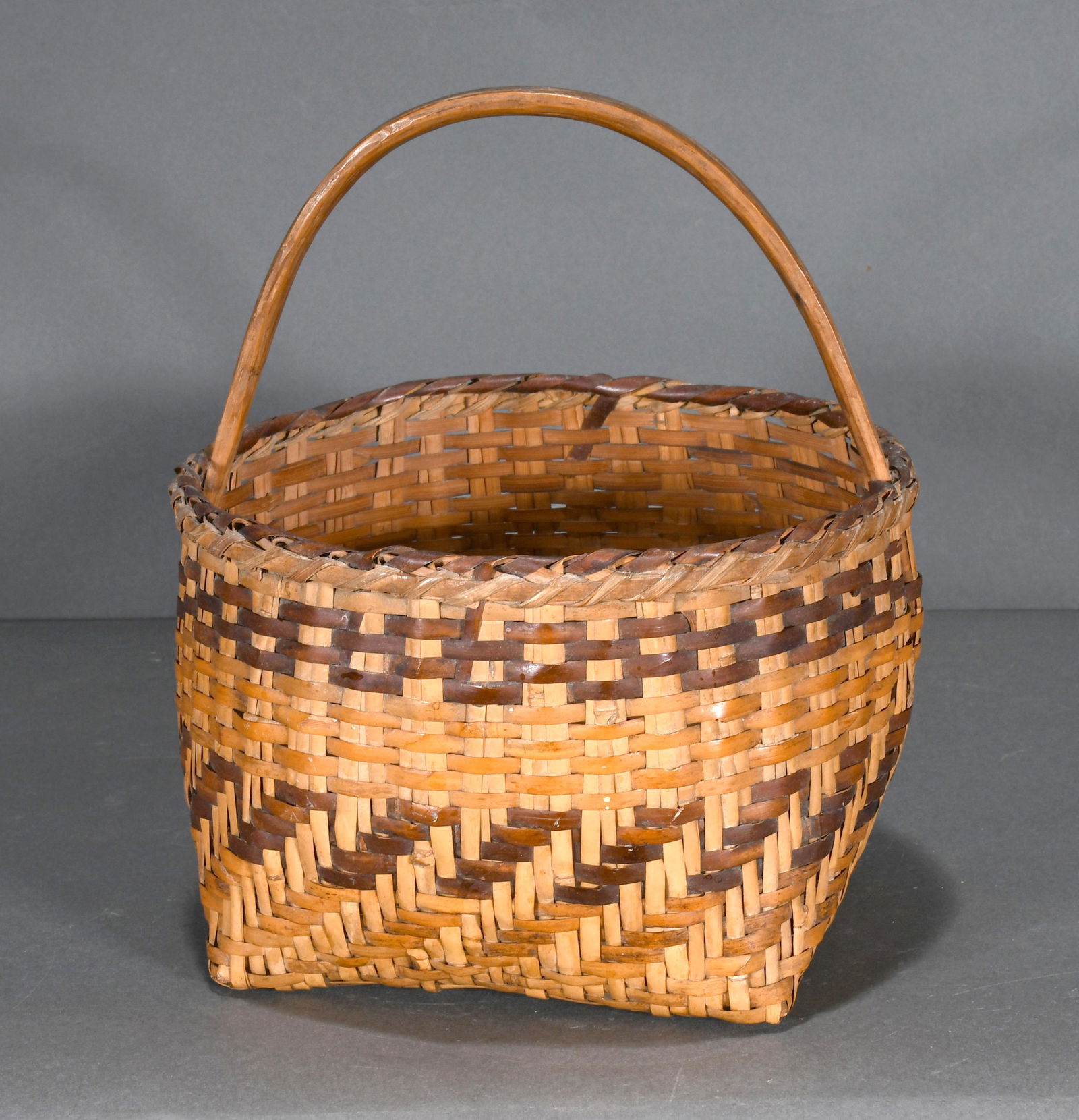Cherokee River Cane and Natural Dye Basket.: Cherokee Basket. River Cane and natural dye. c. 1940's. Excellent condition. 10" h x 8" diameter. Est. $200-400. Ship: $45
