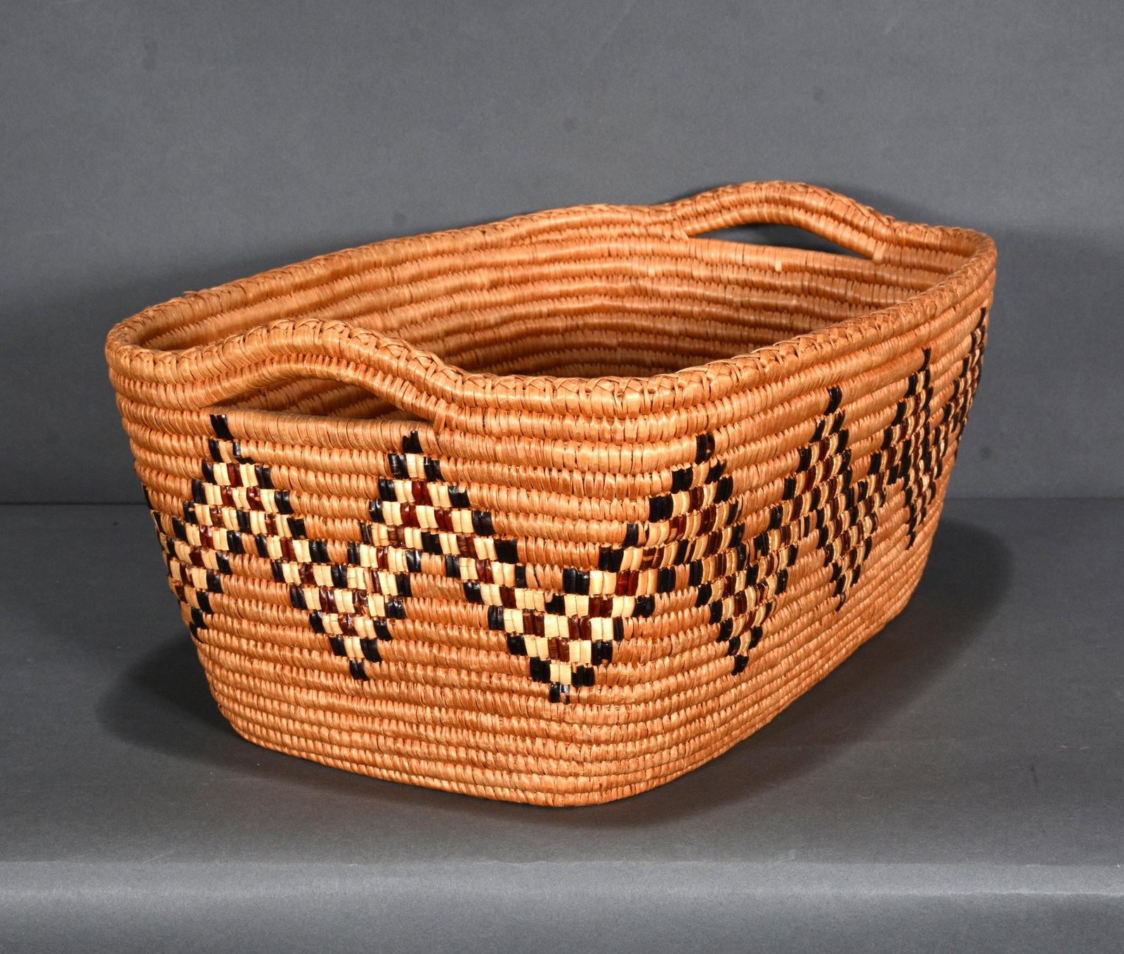 River Cane Picking Basket.: Unknown Maker. Picking Basket. River cane and natural dyes. Excellent condition. 8.5" x 15.5" x 11.5". Provenance: Barbara & Robert Hunter Collection. Est. $200-400. Ship: $45