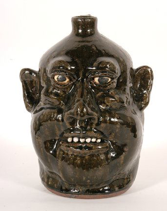 Lanier Meaders. Six Tooth Face Jug.: Lanier Meaders. Six Tooth Face Jug. c. early 1980’s. Nice dark rich glaze throughout. Mint condition. 9.5” h. Est. $1,000-1,500. Ship: $45