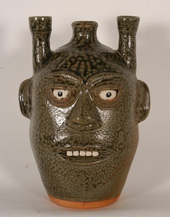 A.G. Meaders. Single Candleabra Face Jug.: A.G. Meaders. Single Candlabra Face Jug. c. 1980’s. Tobacco-spit glaze. Signed. Mint condition. 10.5”h. Est. $300-500. Ship: $45