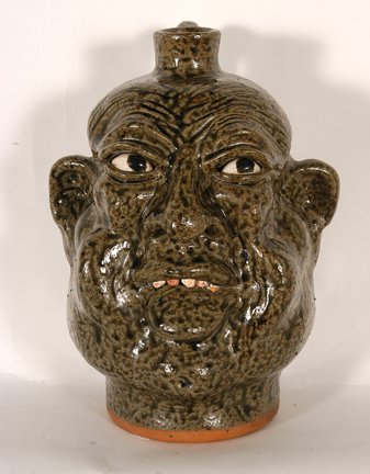 Clete Meaders, Jr. Face Jug.: Clete Meaders, Jr. Face Jug. 1994. Tobacco-spit glaze. Initialed and dated on back of head. Mint condition. 10.5”h. Provenance: The George and Sue Viener Collection. Est. $100-200. Ship: $45