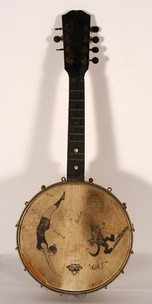 Seifert Banjo. Diving Beauty Banjo.: Seifert Banjo. Diving Beauty Banjo. Signed, “Seifert.” Dated, 1923. Wood, metal and skin. Minor loss of skin, otherwise good condition. 24”h x 9.5” diameter. Est. $300-500. Ship: $35