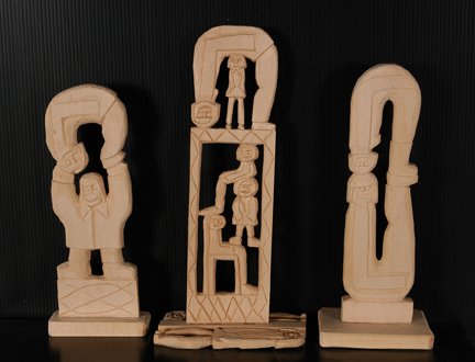 Rev. Herman Hayes. 3 Totems w Top Fig.: Rev. Herman Hayes. Three Totems With Top Figure Bending Over Backwards. 2004-5. Carved balsa wood. Signed and dated. Excellent condition. Largest is 11” x 5” x 3”. Provenance: The Ted Oliver Col