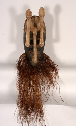 African. Grebo Mask w Raffia Beard.: African. Grebo Mask With 3 Arms & Raffia Beard. Carved wood, painted with seashells. Some gesso covering arms is missing, otherwise good condition. 27” h. Est. $200-400. Ship: $65