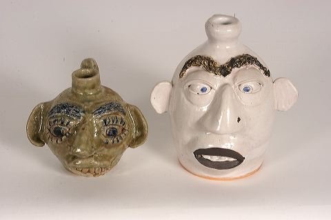 Jerry Brown a& Riley. Face Jugs.: Jerry Brown and Riley. Pair of Face Jugs. Riley is white glaze, 1990, 7 h. Jerry Brown piece is from 1992. Both are mint condition. Provenance: The Lynne Ingram Collection. Est. $100-200. Ship: $50