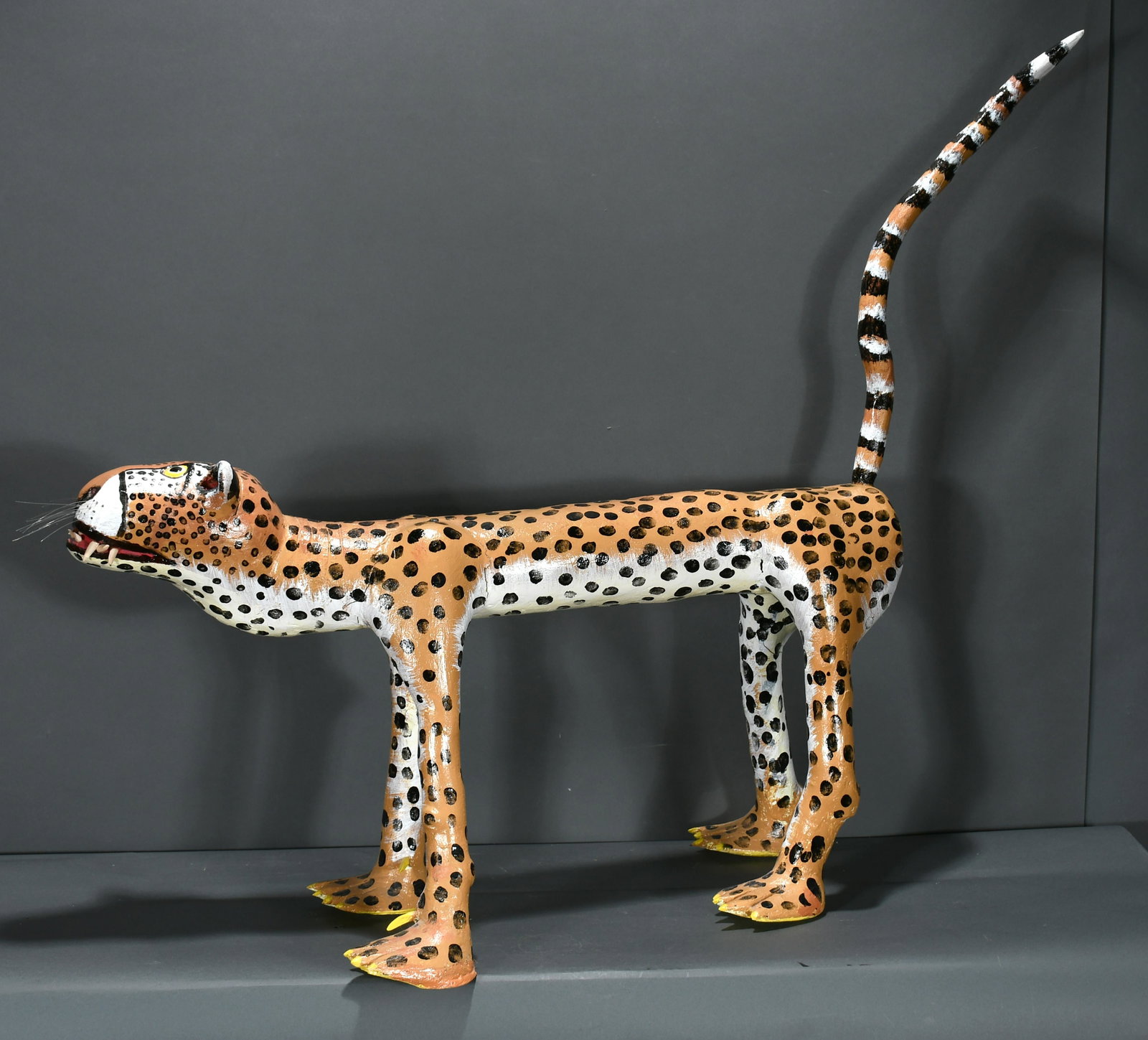 Isaac Smith. Cheetah.: Isaac Smith. Cheetah. Carved and painted wood. Right back leg has repair, some separation on left front leg otherwise good condition. 35" x 19" x 12.5". Est. $200-300. Buyer is responsible for shippin