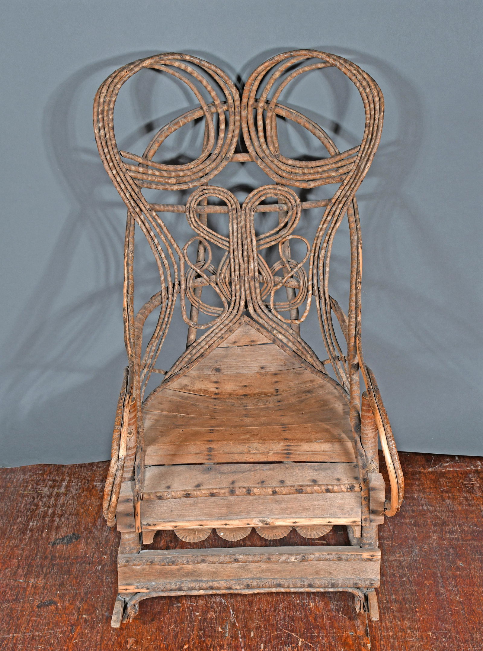 Winged Back Primitive Willow Rocker. Auction