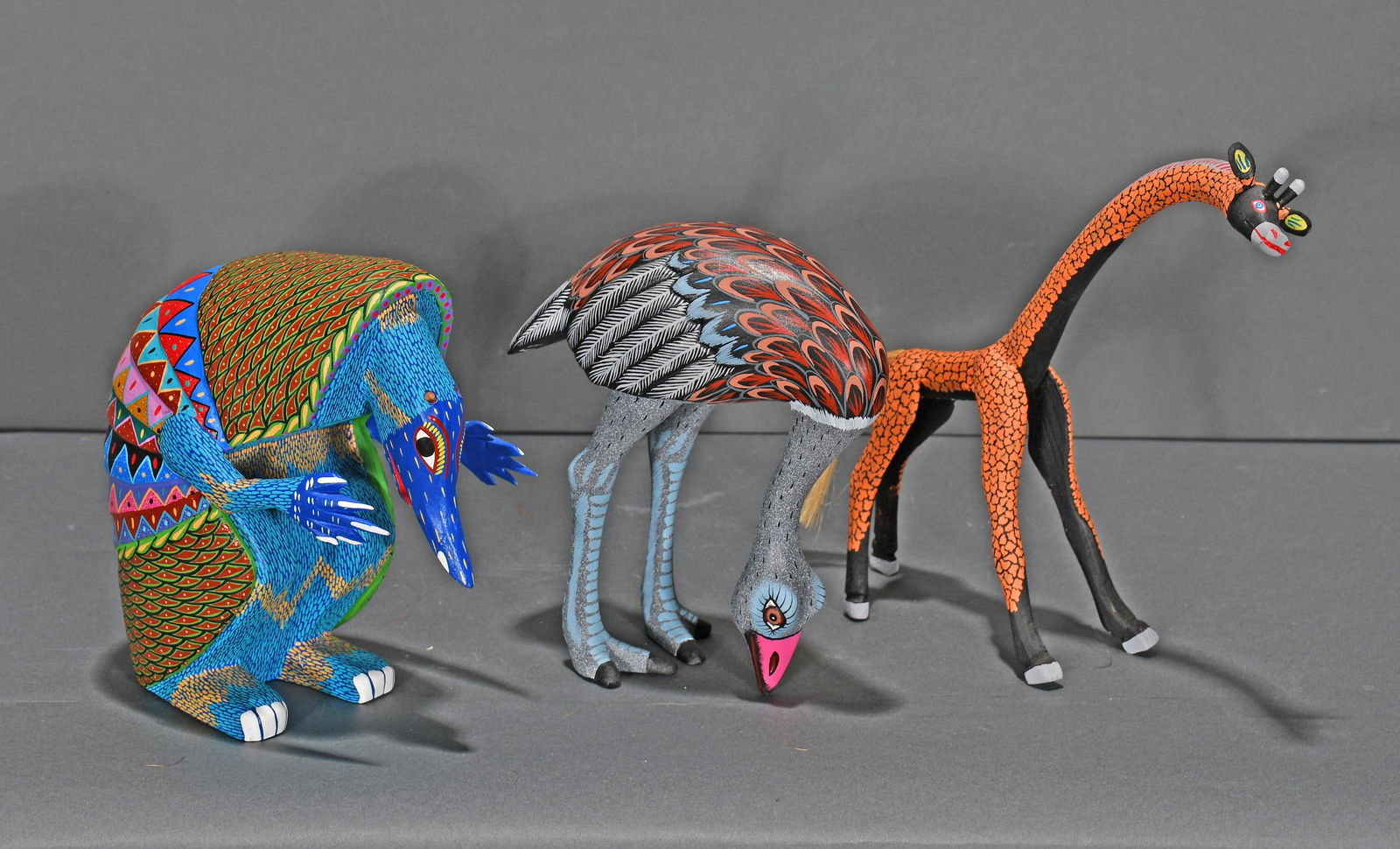 Carlos, Melchor, Morales. Ostrich, Giraffe, Armadillo.: Juan Carlos, Jesus Melchor, Elfazar Morales. Carved Ostrich, Giraffe & Armadillo. Signed. Carved and painted wood. Excellent condition. Average size is 7"h. Est. $200-300. Ship: $75