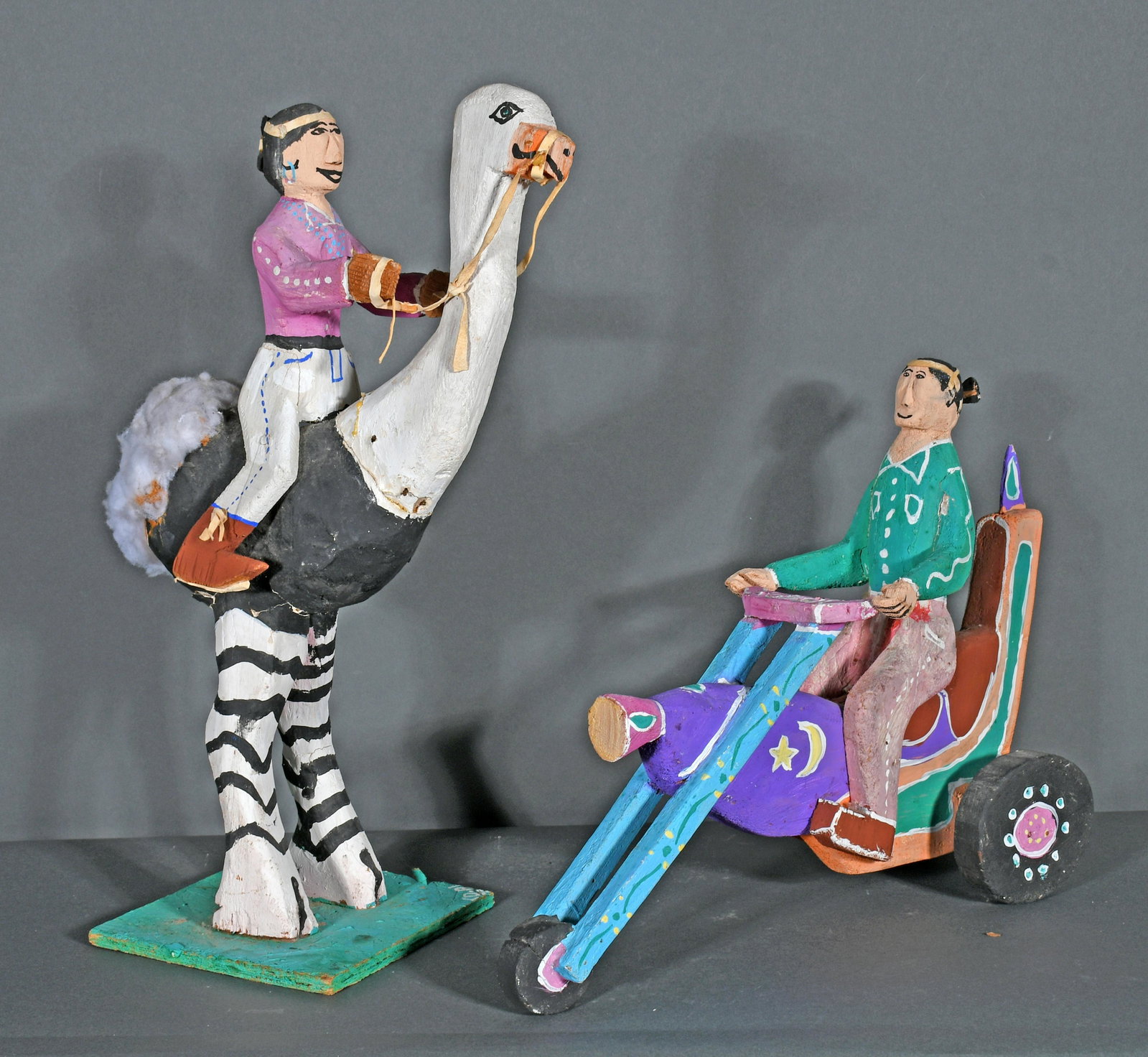 Delbert Buck. Man On Ostrich & Biker.: Delbert Buck. Man On Ostrich and Biker. Signed. Carved and painted wood. Breaks and repairs, otherwise fair to poor condition. Tallest is 18"h. Est. $50-100. Ship: $150