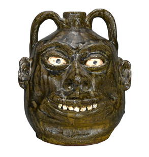 Lanier Meaders. Double Face Rock Tooth Jug.: Lanier Meaders. Double Face Rock Tooth Jug with Deep Rich Tobacco Spit Glaze. c. 1960's. Signed. Perfect quartz and granite teeth. Minor shrinkage on one lip, otherwise mint condition. 9.5" h. Est.