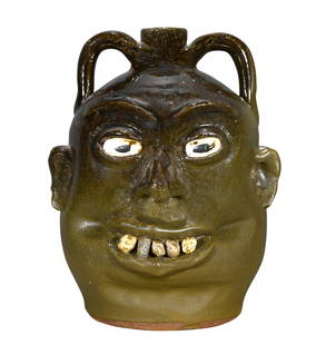 Lanier Meaders. Double Face Rock Tooth Jug.: Lanier Meaders. Double Face Rock Tooth Jug. c. 1960's. Signed. Extraordinarily large and well preserved rock teeth. Half high glaze and half matte glaze. Minor shrinkage on back side of lip, otherwise