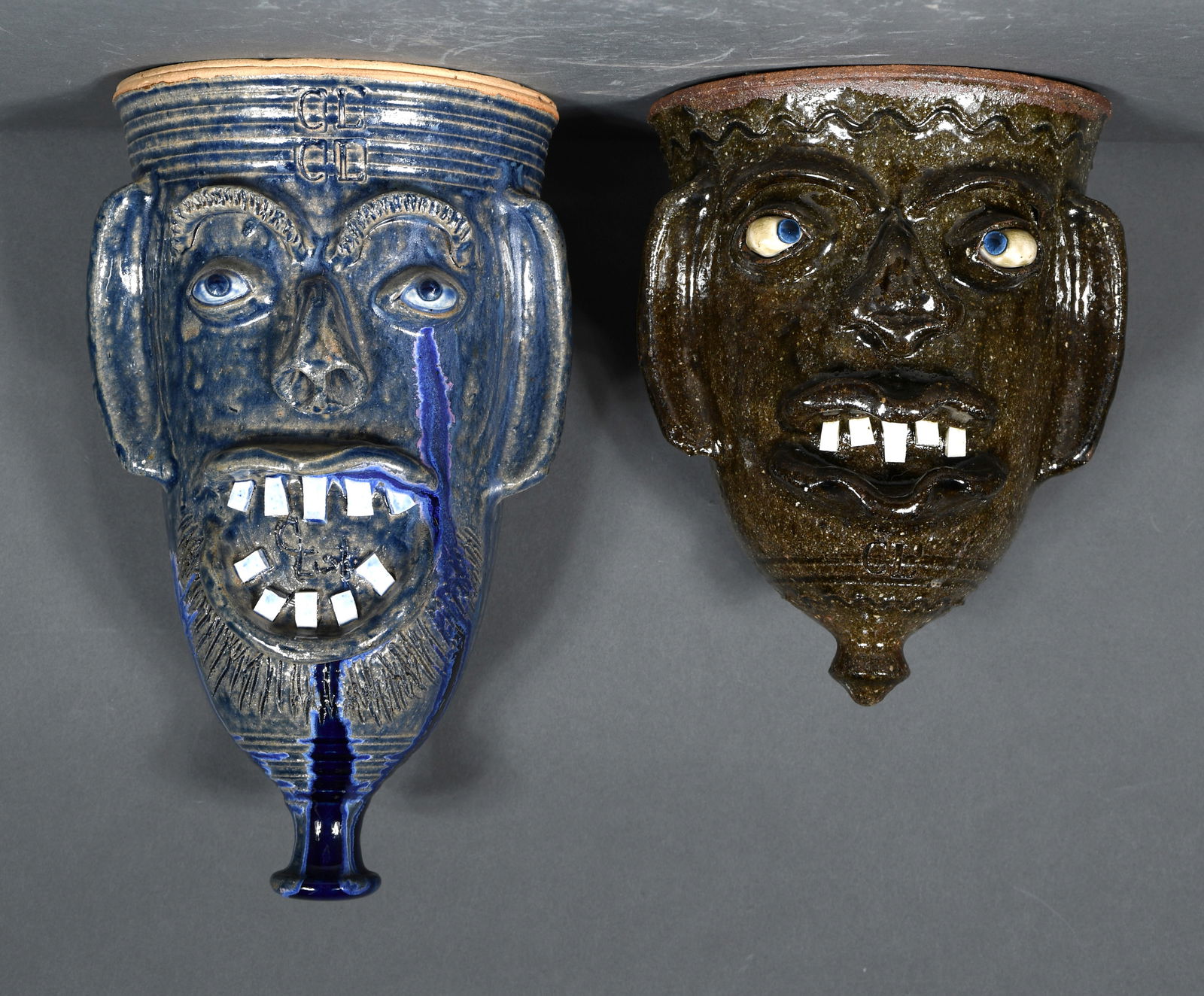 Charles Lisk.  Blue and Ash Glaze Face Wall Pockets. (1 of 2)
