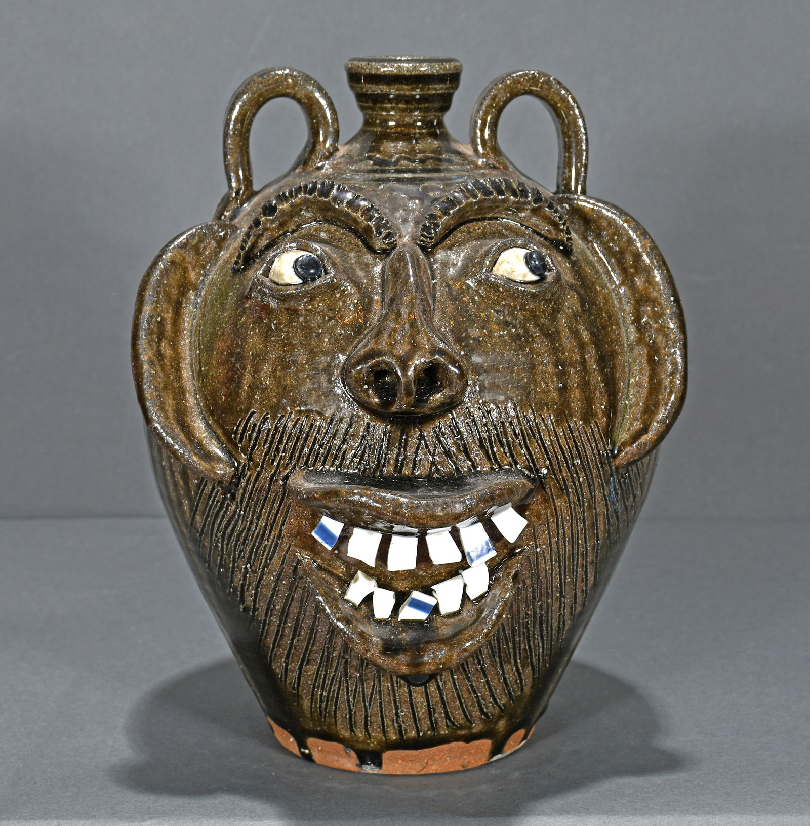A.V. Smith. Ash Glaze Laughing Face Jug.: A.V. Smith. Ash Glaze Laughing Face Jug. Signed. Tobacco-Spit drips and china plate teeth. Mint condition. 10.5" h. Est. $200-300. Ship: $55