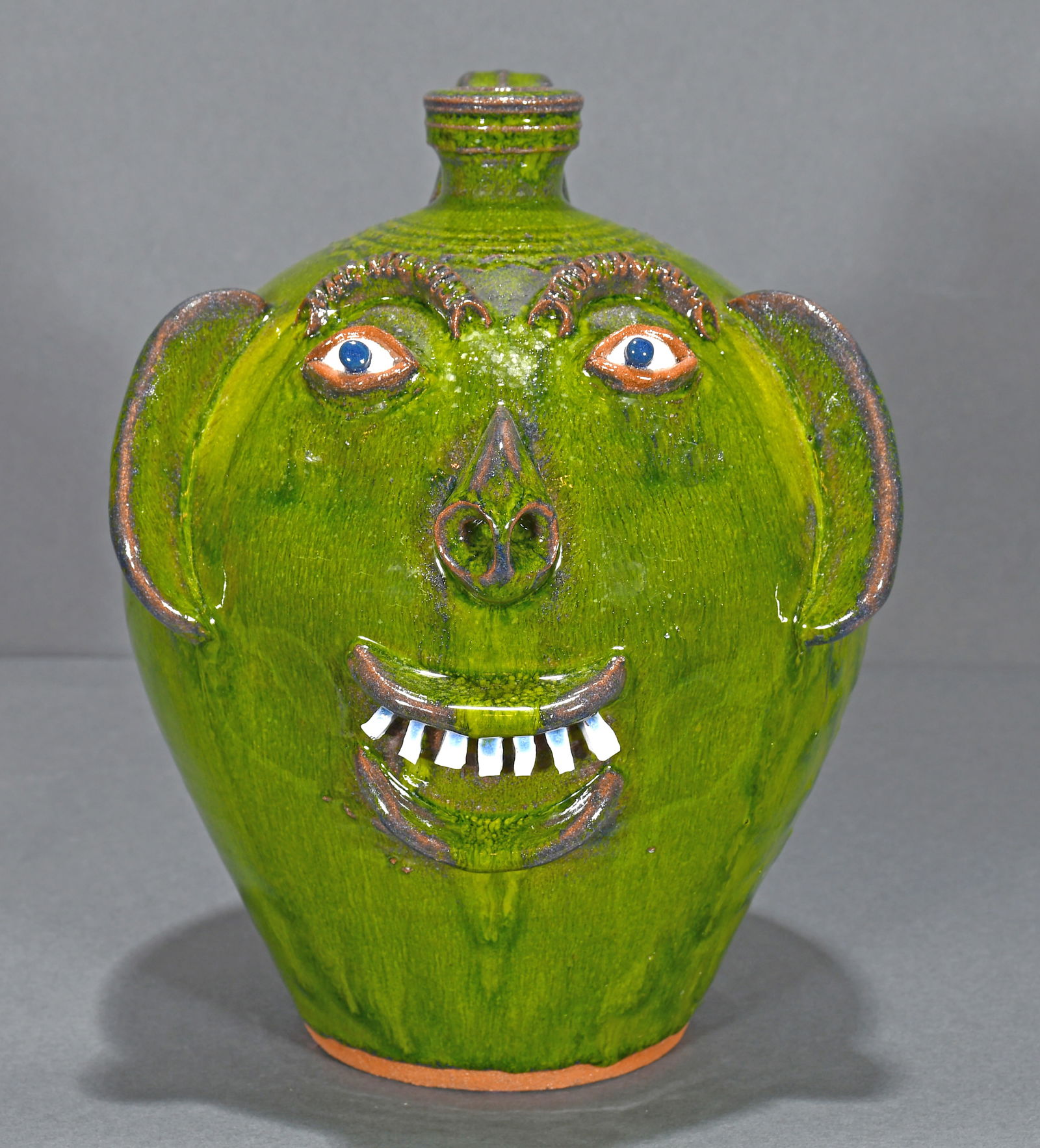 A.V. Smith.  Smiling Forest Green Face Jug. (1 of 5)