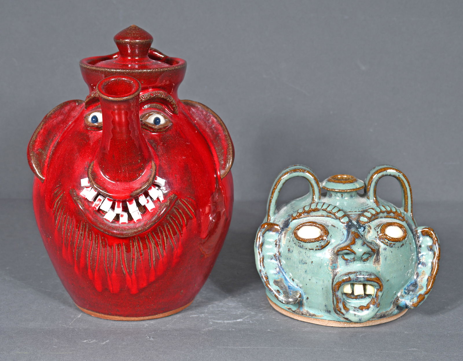 A.V. Smith.  Red Tea Pot Face Jug and Green Buggy Jug. (1 of 3)
