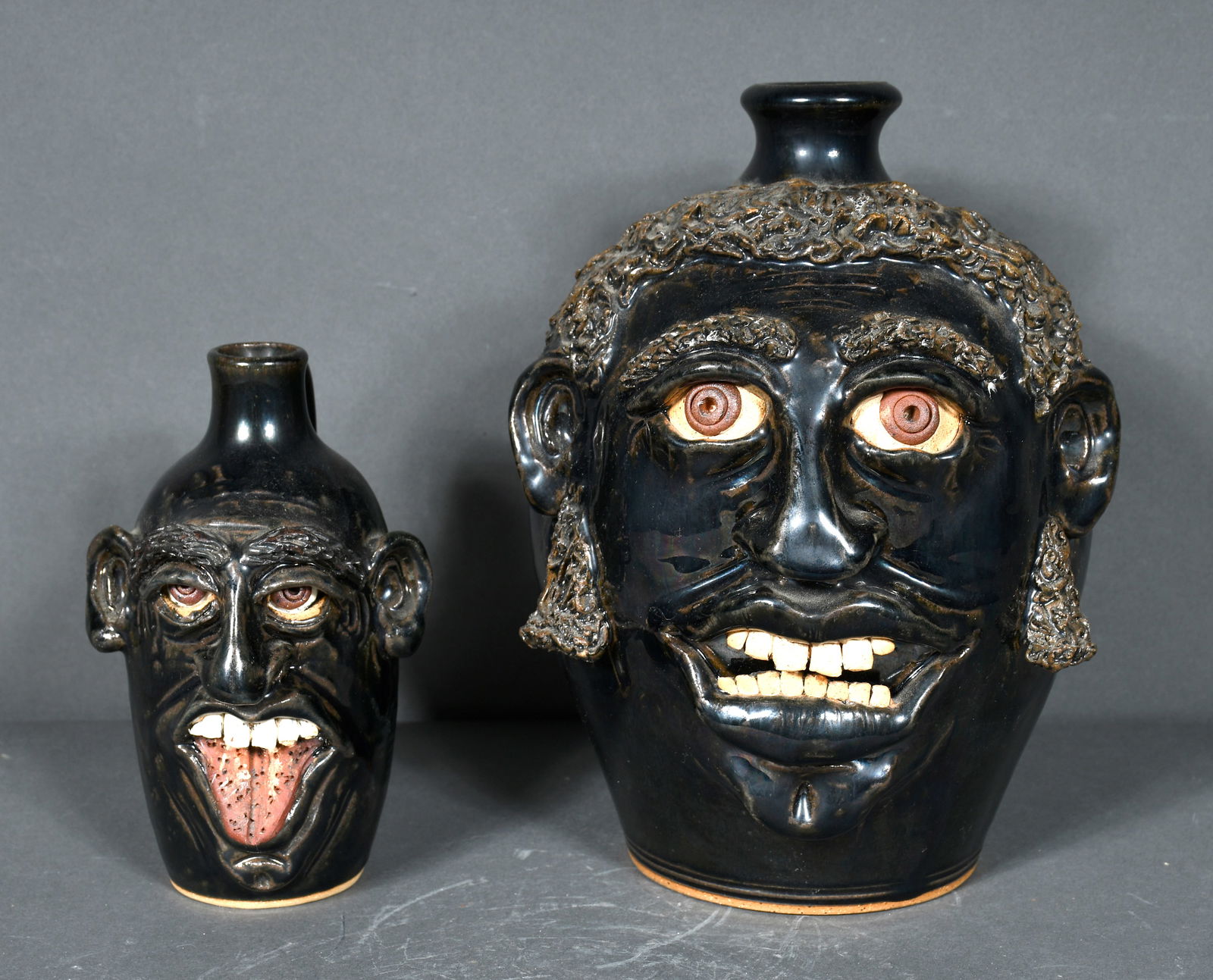 Sandy Cole.  Pair of Black Glaze Face Jugs. (1 of 3)