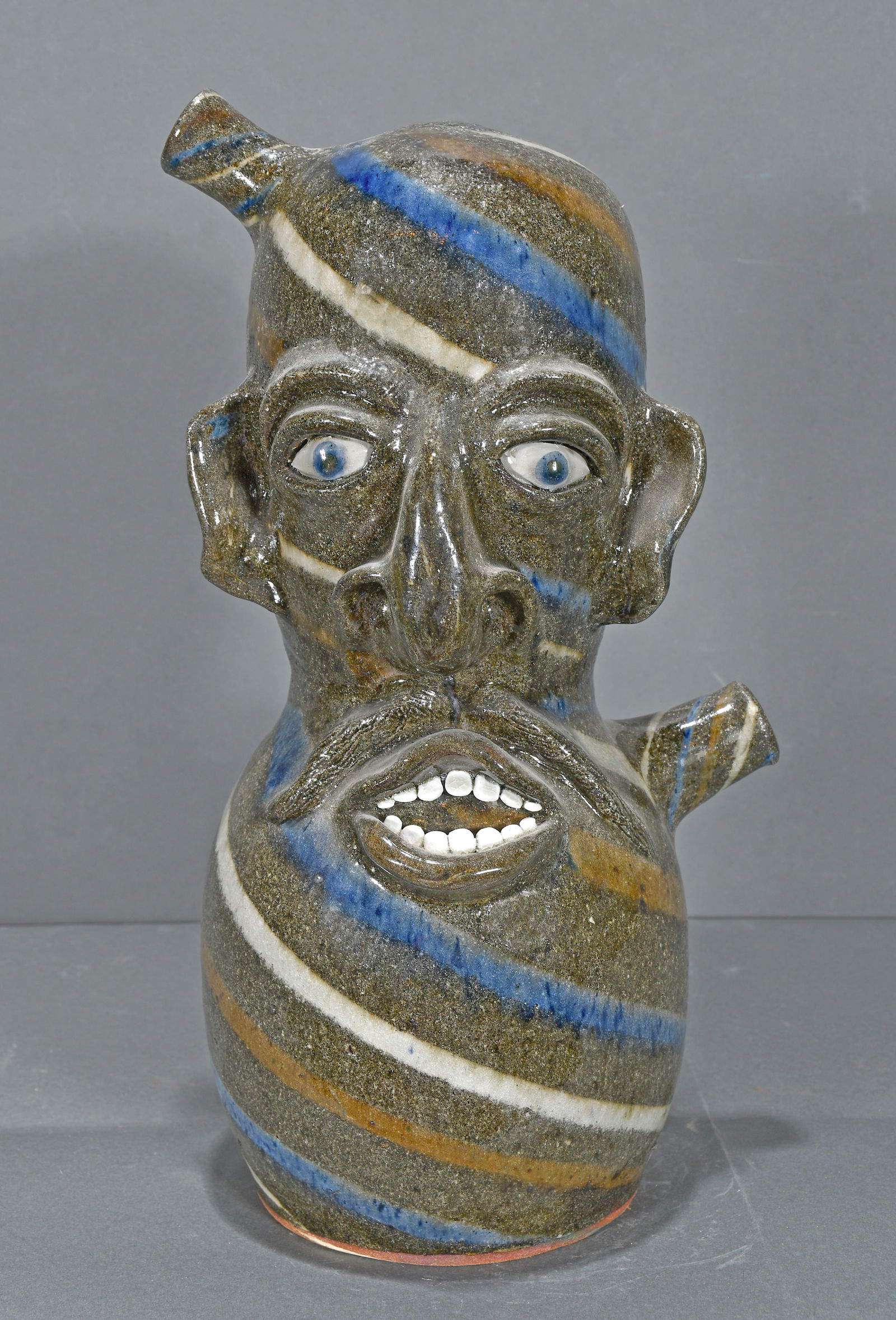 Joe Reinhardt.  Four Color Swirl Double Spout Face Jug. (1 of 3)