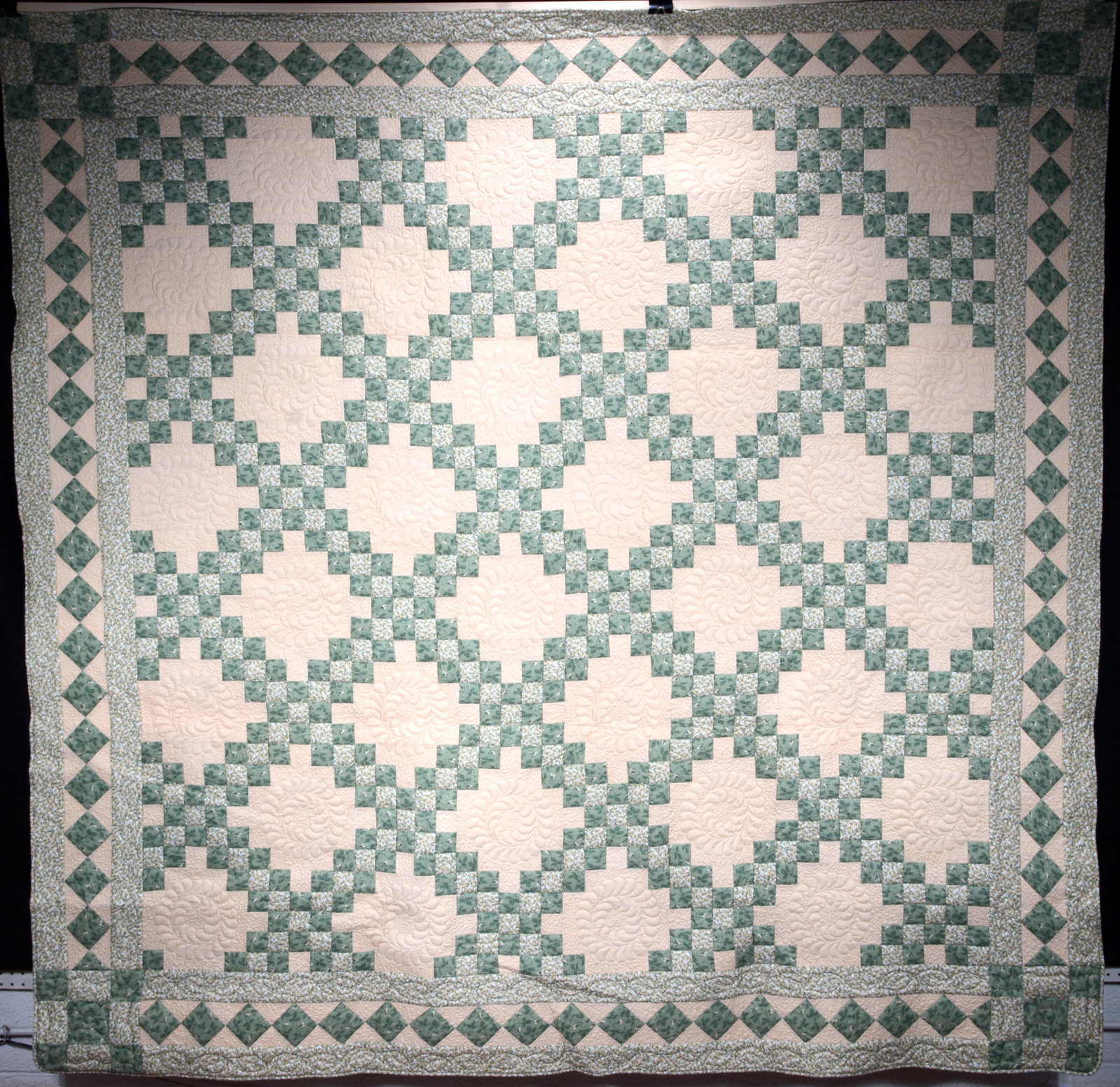 Green & Yellow Wreath Designs Cotton Quilt. R[1]C: Anonymous. Green & Yellow Wreath Designs Cotton Quilt. Not signed or dated. Machine stitched trapunto cotton. Excellent condition. 92" x 91". Provenance: Barbara and Robert Hunter Collection. Est. $30
