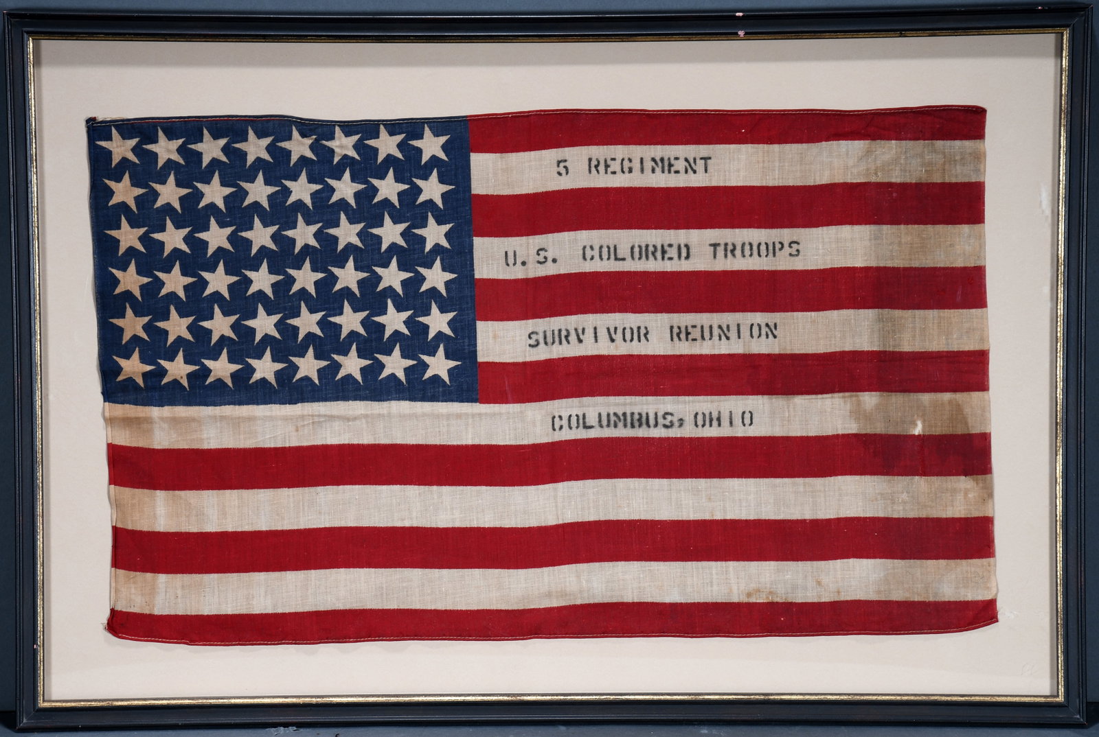 48 Star National Flag. Fifth Regiment U. S. Colored Troops Survivor Reunion Flag.: 48 Star National Flag. Fifth Regiment U.S. Colored Troops Survivor Reunion Flag. c. 1915. Columbus, OH. Stenciled in color on muslin. Staining on right side with minor loss, toning and aging consisten