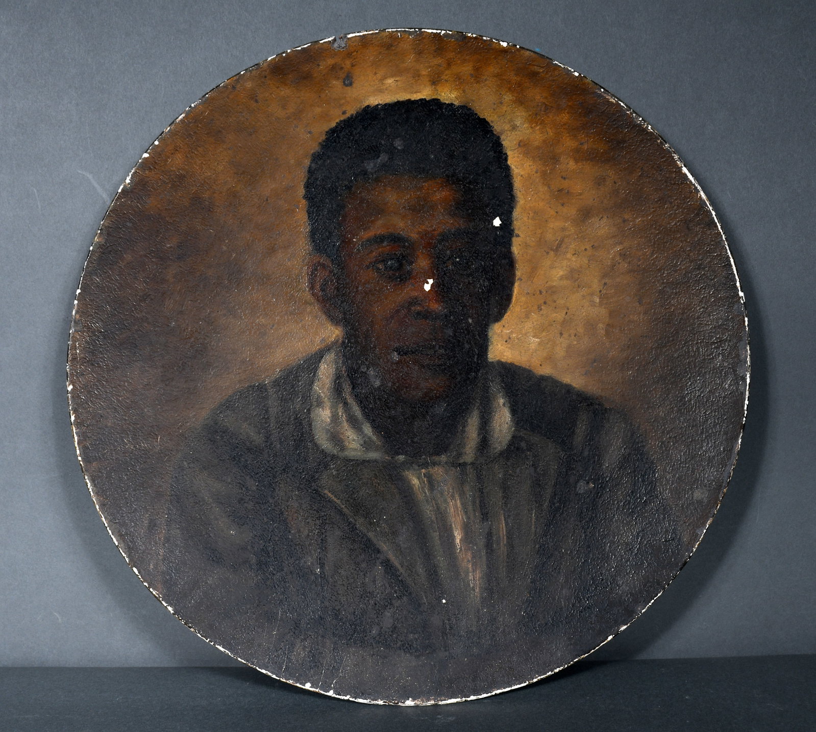 Anonymous. Portrait of Young Black Man.: Anonymous. Portrait of Young Black Man. c. late 1800's. Oil on gesso covered fiber charger. Paint chips on face, otherwise good to fair condition. 18" diameter. Provenance: The Richard Harris African 