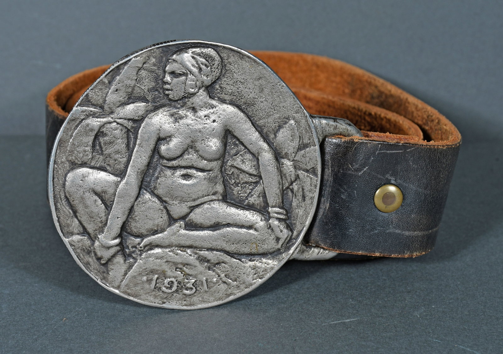 Large Lead Belt Buckle with Female Figure and Leather Belt.: Anonymous. Large Lead Belt Buckle with Female Figure and Leather Belt. 1931. Excellent condition. Buckle is 3.75" diameter. Provenance: The Richard Harris African American Experience Collection. Est. 