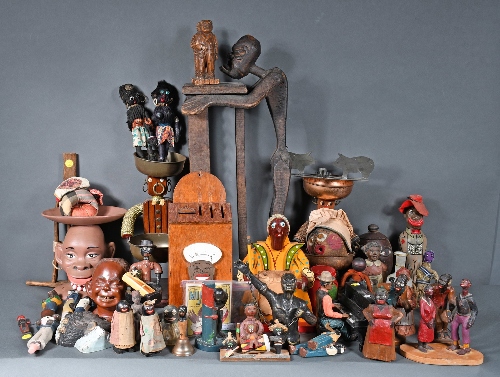 Box Lot of Stereotypical African American Trinkets and Souvenirs.: Anonymous. Box Lot of Stereotypical African American Trinkets and Souvenirs. Mixed media. Good to fair condition. Largest piece is 26" h. Provenance: The Richard Harris African American Experience Col