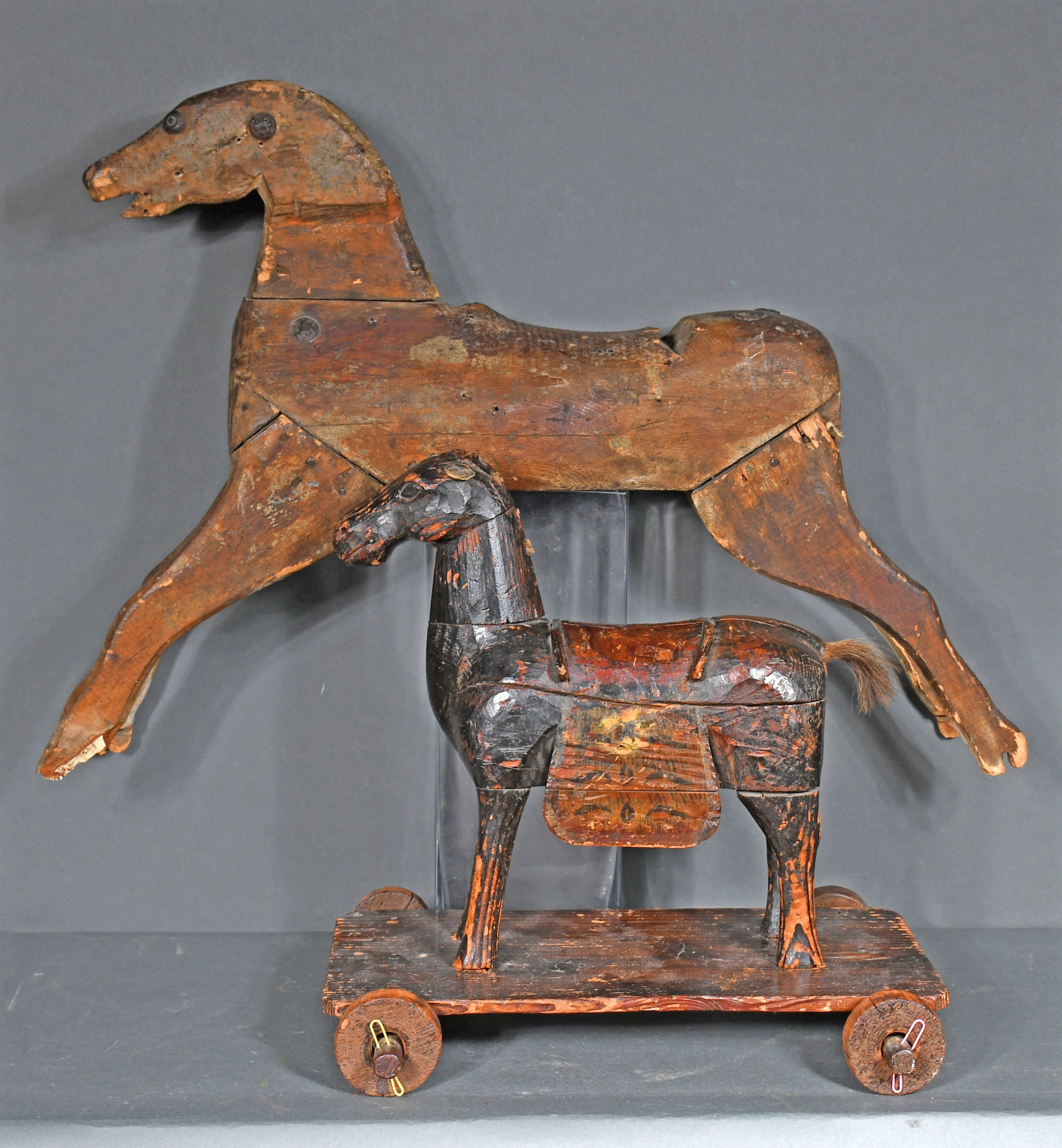 Pair of Early Wooden Horses.: Anonymous Pair of Early Wooden Horses. Carved wood constructions with mixed media. Lots of wear and minor loss consistent with age, otherwise good to fair condition. 33" long x 21" h. Provenance: The 