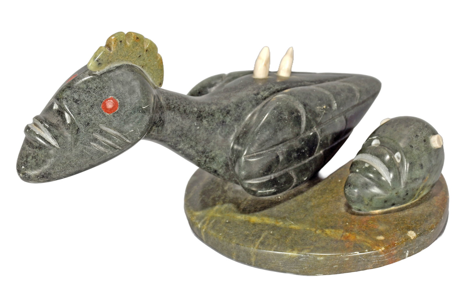 Floyd Kuptana. Inuit Spirit Fable.: Floyd Kuptana. Spirit Fable. 1999. Signed and dated. Carved serpentine and bone. Missing part in face otherwise great condition. 11” w x 5" h. Est. $200-400. Ship: $65