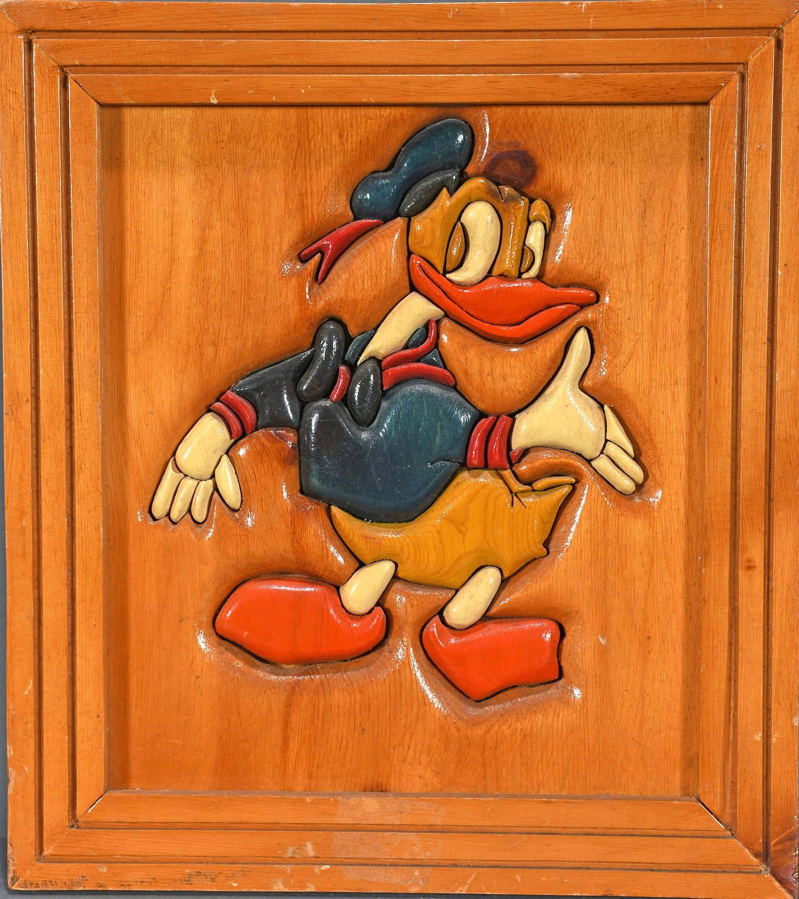 Donald Duck Carved Plaque.: Unknown Artist. Donald Duck. Carved and painted wood. Excellent condition. Size with frame is 14" w x 16" h. Est. $100-200. Ship: $45