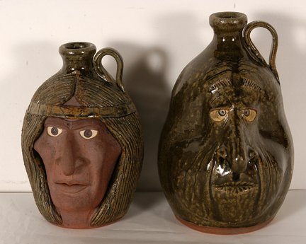 Michael & Melvin Crocker. Indian & Goofy Faces.: Michael & Melvin Crocker. Indian and Goofy Face Jugs. 1993. Signed and dated. Indian is in mint condition. Goofy face has repar to handle, otherwise good condition. Tallest is 8.5” h. Est. $200-300.
