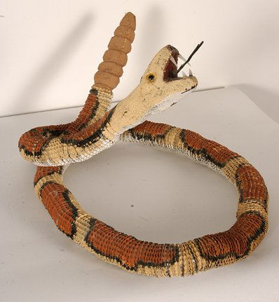Leroy Archuleta. Bottlecap Desert Rattler.: Leroy Archuleta. Bottlecap Desert Rattler. Signed. Not dated. Bottlecaps, paint, wire and wood. 54” long. Provenance: The Private Collection of Chuck and Jan Rosenak. Est. $300-500. Ship: $45