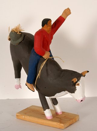 Ned Tom. Riding The Black Bull.: Ned Tom. Riding The Black Bull. Not signed or dated. Carved and painted wood with straw. Excellent condition. 12” x 9” x 4”. Est. $100-300. Ship: $65