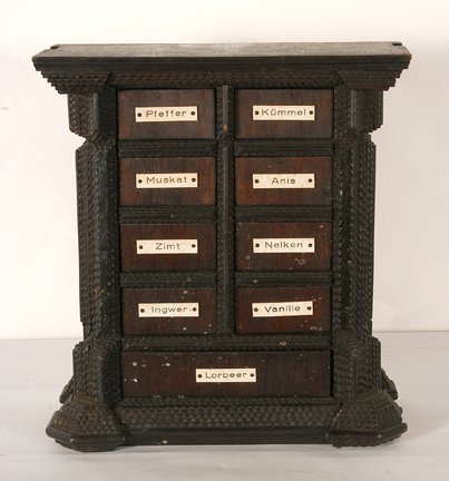Tramp Art Apothecary Spice Box: Anonymous Tramp Art Apothecary Spice Box. Not signed or dated. Carved and chipped wood with spice name plates. Excellent condition. Possible German origin. 14” x 15” x 6”. Est. $200-300. Ship: $