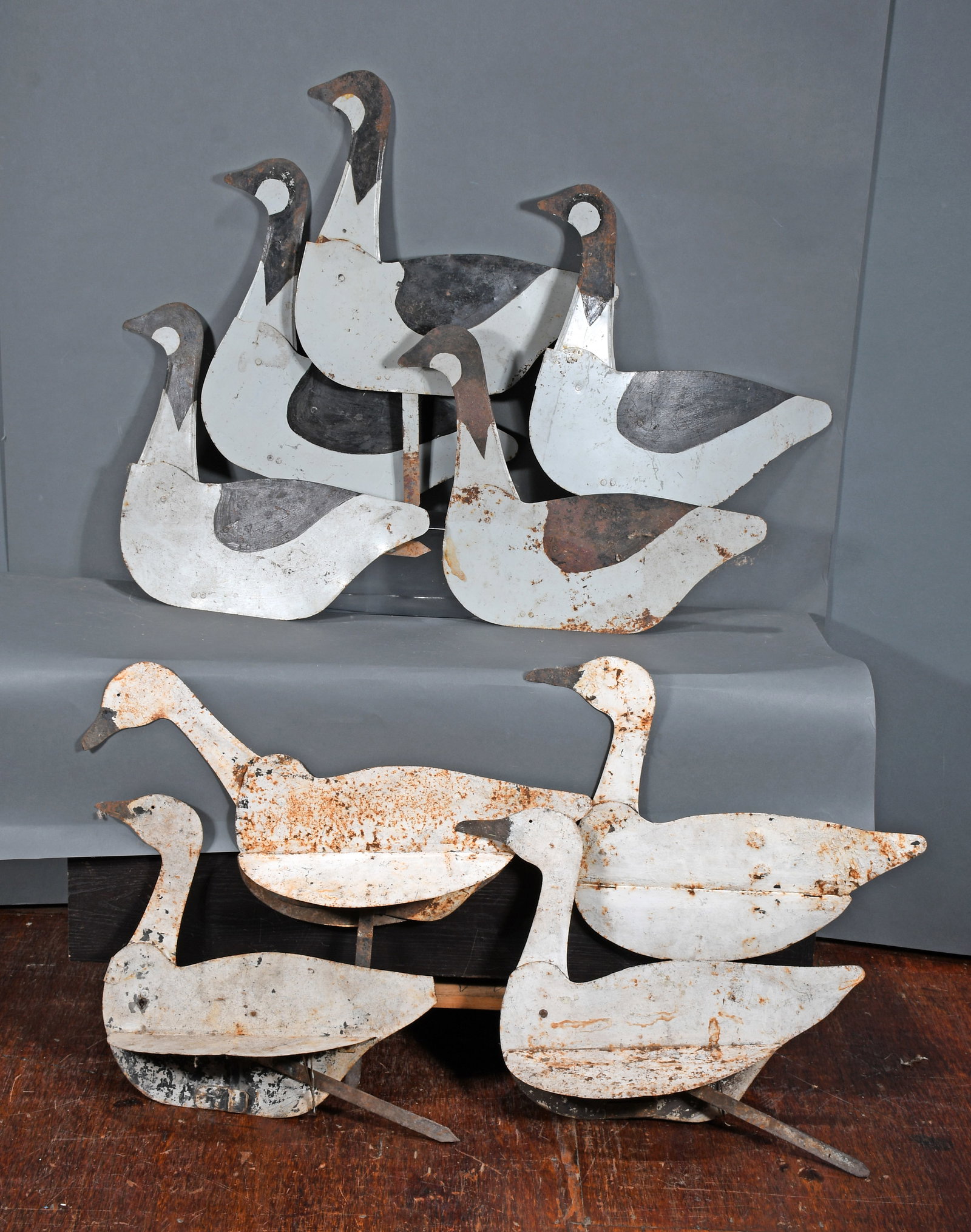 Gaggle of Geese and Swan Decoys.: Anonymous. Gaggle of Geese and Swan Decoys. Paint on metal. Expected environmental wear and rust, otherwise good condition. Average body size is 19" w x 19" h. Est. $500-800. Ship: $100