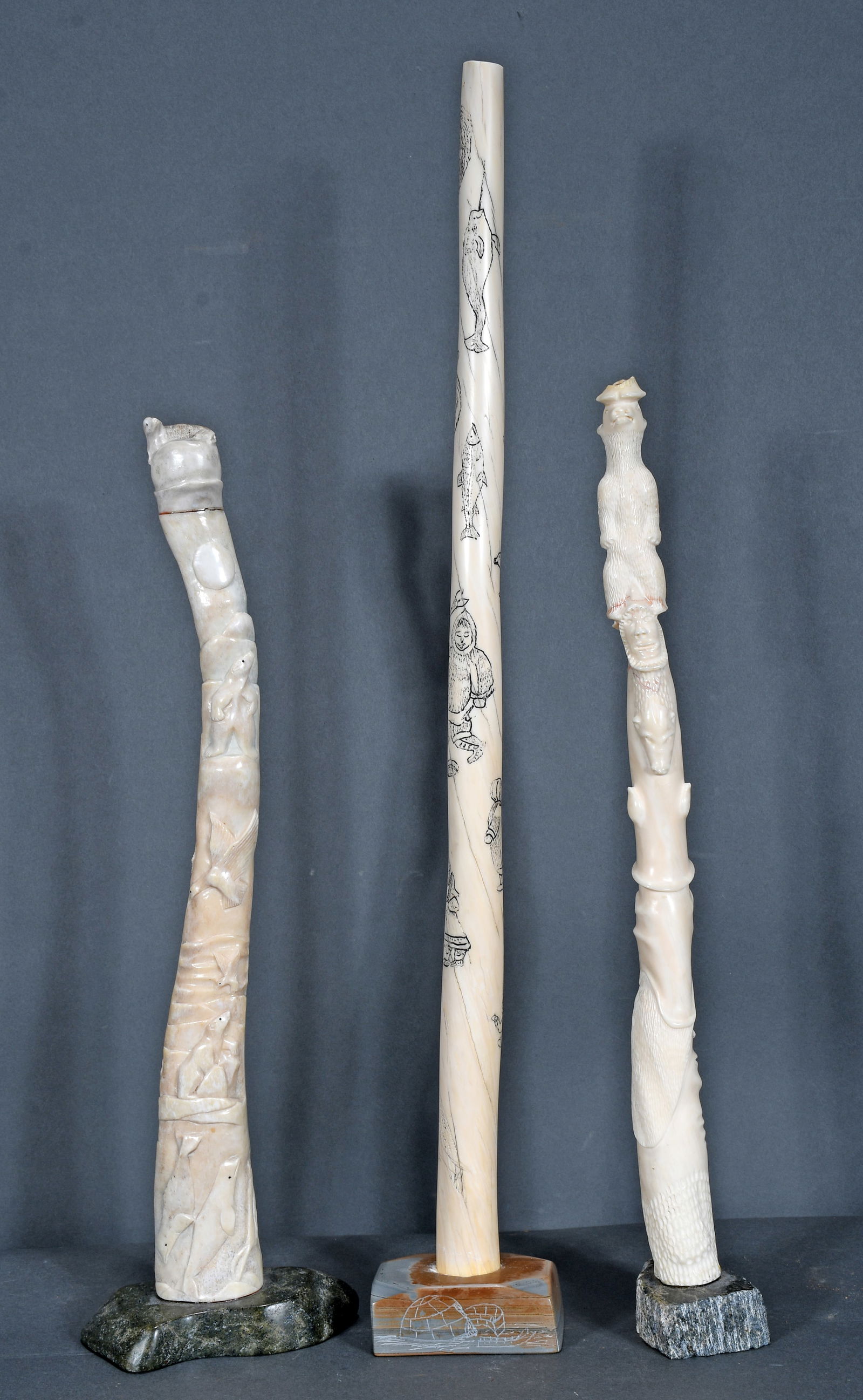 Arakaluk & Tatuapin. Three Inuit Bone carvings.: Arakaluk, Tatuapin & Unknown. Three Inuit Bone carvings. Carved natural material with stone bases. Left and right carvings have some breaks and repairs, otherwise excellent condition. Largest is 24" h