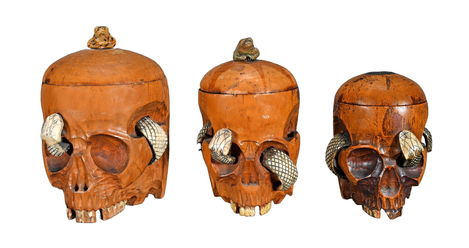 Graduated Decanter Set of Skulls and Snake Humidor.: Anonymous. Graduated Decanter Set of Skulls and Snake Humidor. Carved and stained wood with bone snakes. Loss on snakes tails otherwise great condition. Largest is 7" h. Est. $300-500. Ship: $65