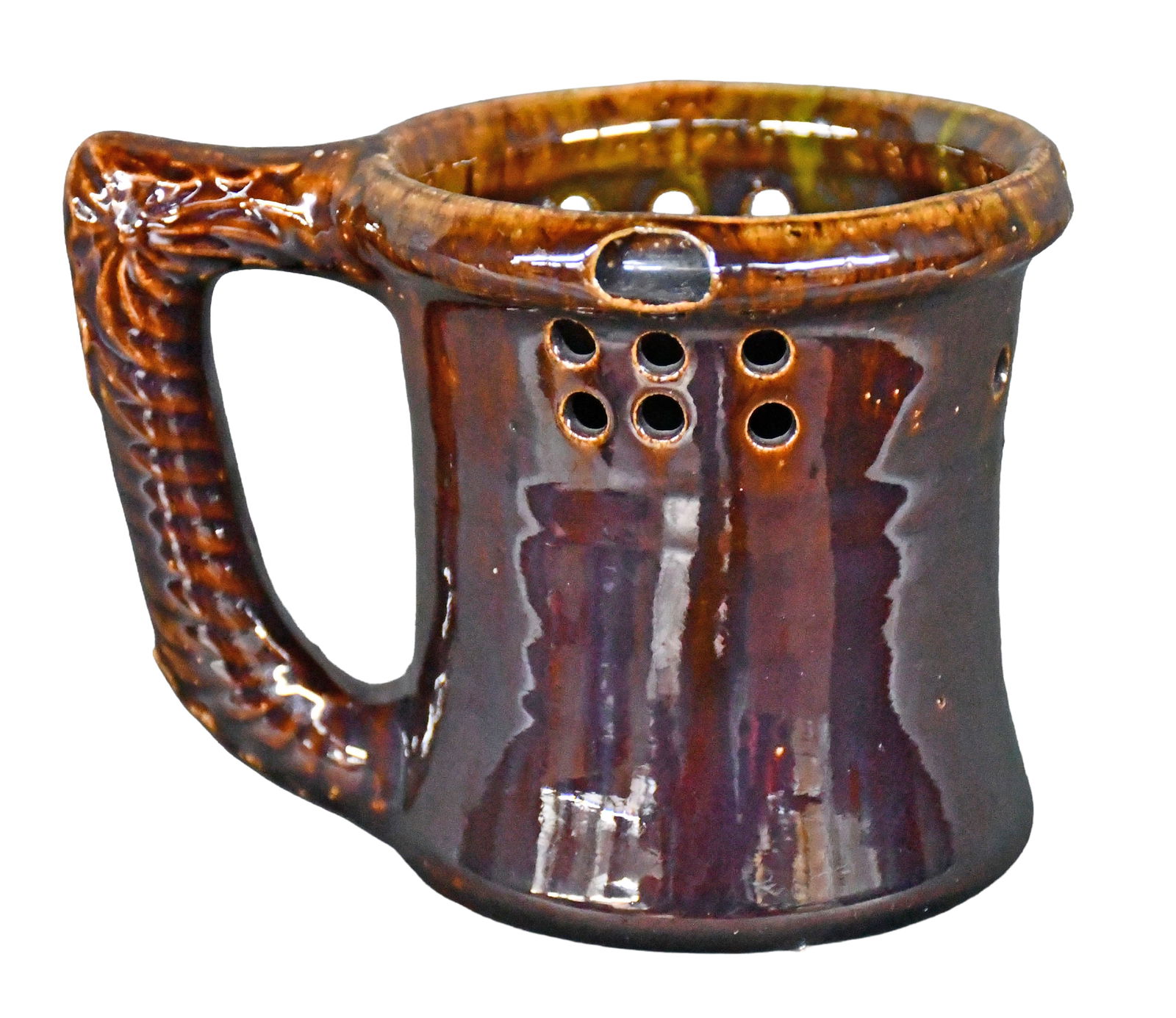 George Ohr. Puzzle Mug.: George Ohr. Puzzle Mug. Signed in script. Dark amber brown glaze. Mint condition. 3.5" h. Est. $800-1,200. Ship: $45 Please Read Before You Bid: By registering for and/or placing a bid in any