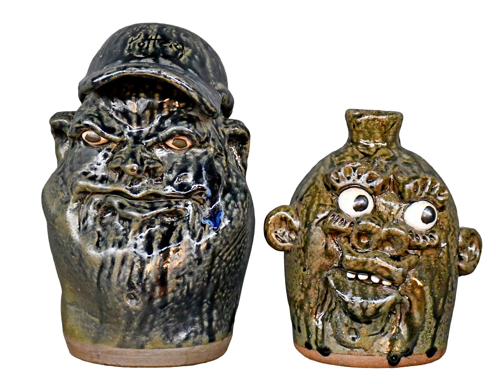 Clete Meaders, Jr. Pair of Face Jugs.: Clete Meaders, Jr. Pair of Face Jugs. 1994/2006. Signed and dated. Mint condition. Tallest is 10" h. Est. $200-300. Ship: $85 Please Read Before You Bid: By registering for and/or placing a bid in