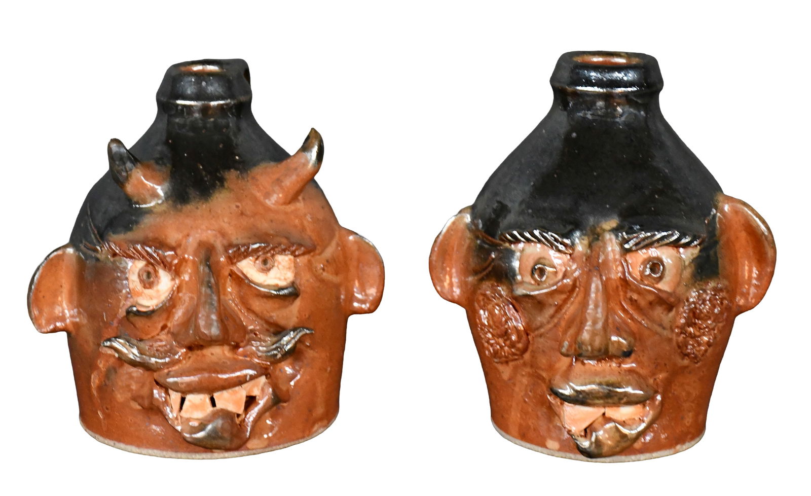 Randy Myers (attributed). Two-Tone Glazed Face Jugs.: Randy Myers - attributed. Pair of Two-Tone Glazed Face Jugs. 1998. Not signed, but dated. Average is 7.5" h. Est. $100-200. Ship: $85 Please Read Before You Bid: By registering for and/or placing