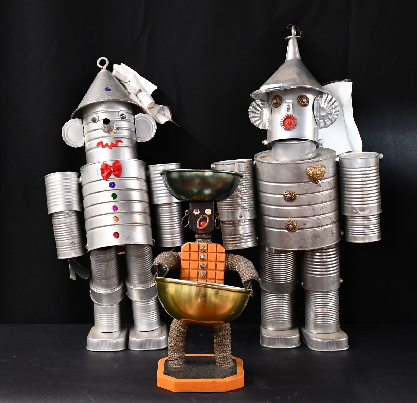 Pair of Tin Men and Bottlecap Figure.: Anonymous. Pair of Tin Men and Bottlecap Figure. Not signed. Aluminum cans and mixed media constructions. Good condition. Tallest is 25" h. Est. $50-100. Ship: $100 Please Read Before You Bid: By