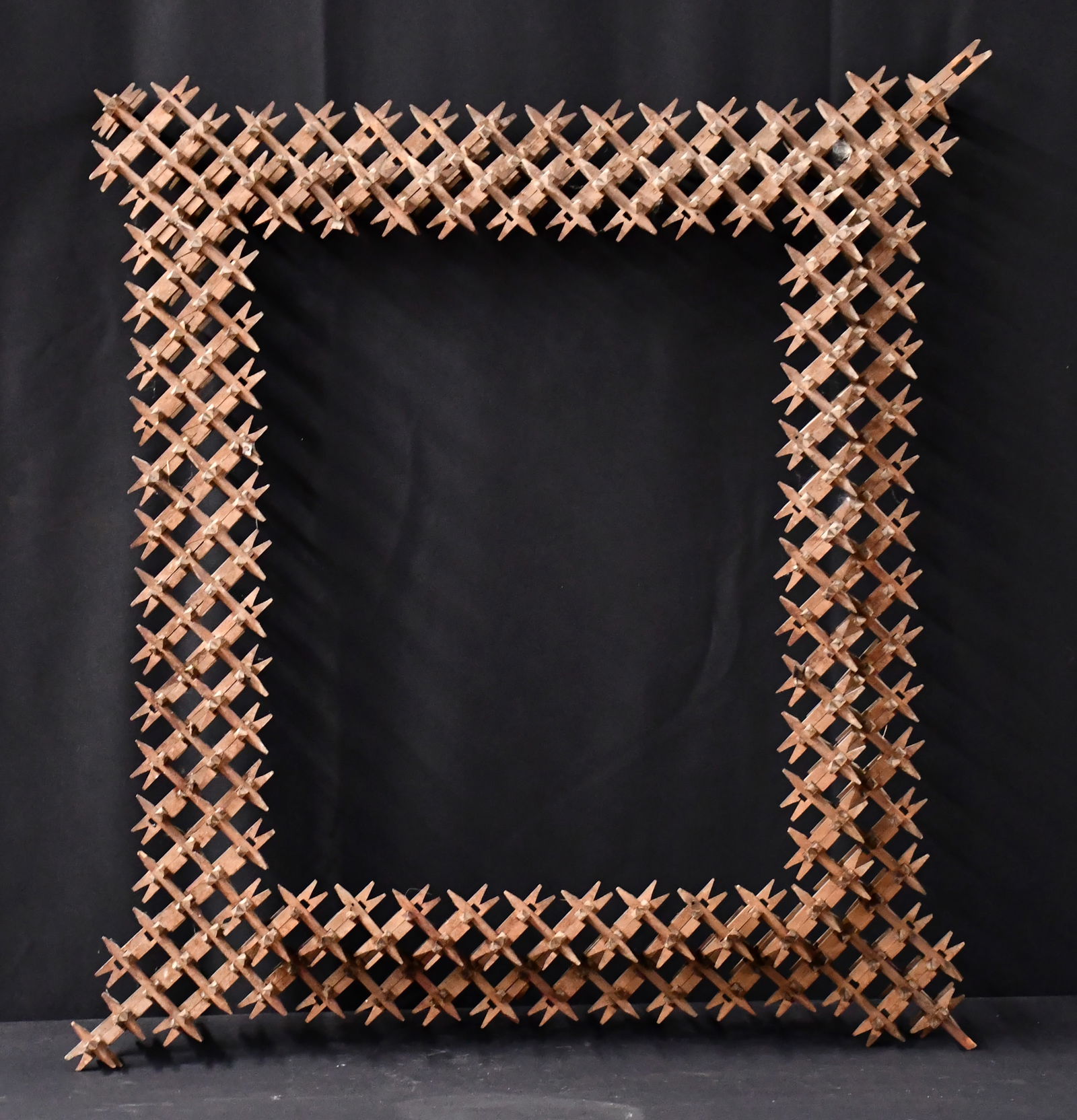 Crown of Thorns Tramp Art Frame.: Anonymous. Crown of Thorns Tramp Art Frame. Not signed. Assembled and stained wood. Minor loss, otherwise good to fair condition. 25" w x 31" h. Est. $100-200. Ship: $250 Please Read Before You