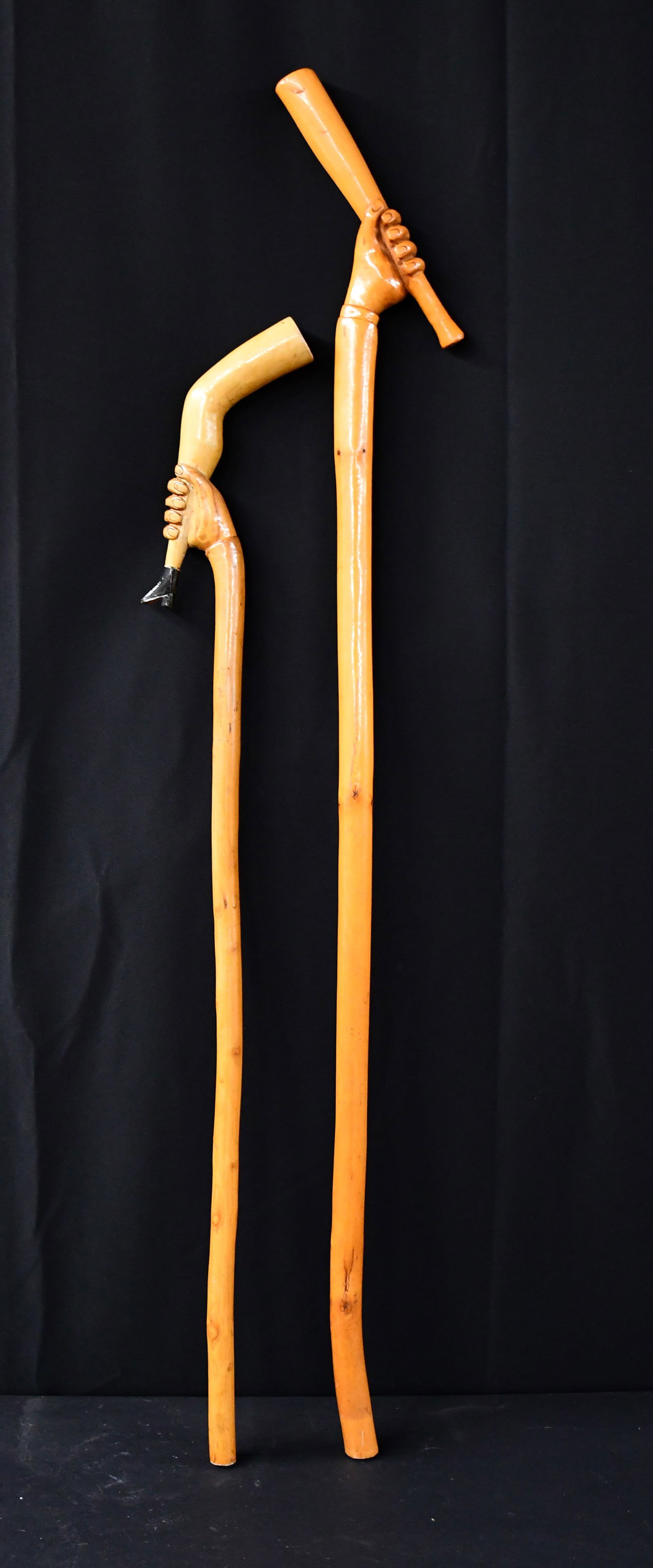 Silas W. Pair of Hand Holding Bat and Lady's Leg Canes. (1 of 4)