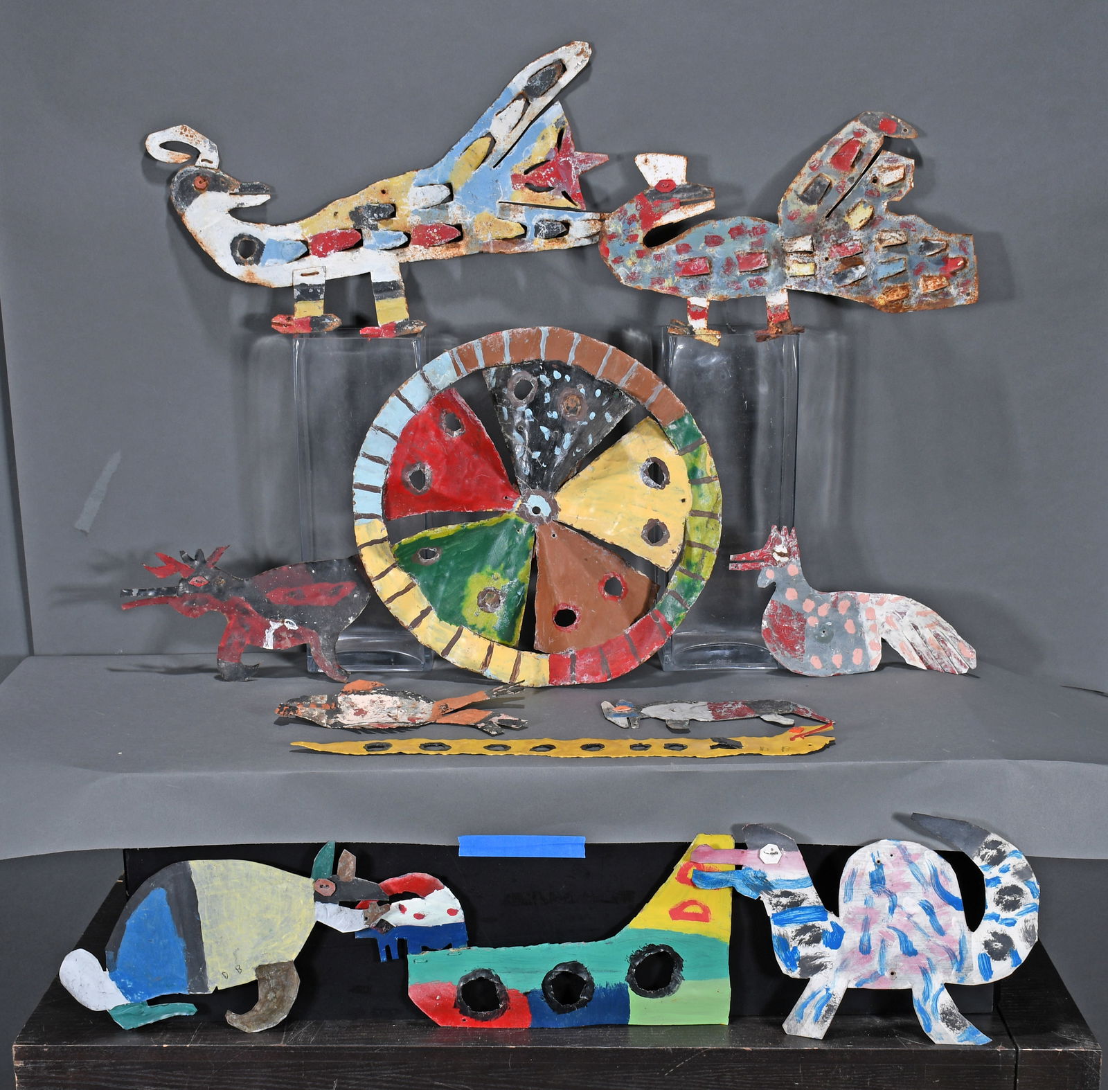 David Butler. Peacocks, Whirligig Wheel and Animals. 11 Works.: David Butler. Group Lot with Peacocks, Whirligig Wheel and Other Animals. 11 Works. Some are initialed. Paint on cut out tin with mixed media. Some environmental weathering and paint loss. Overall