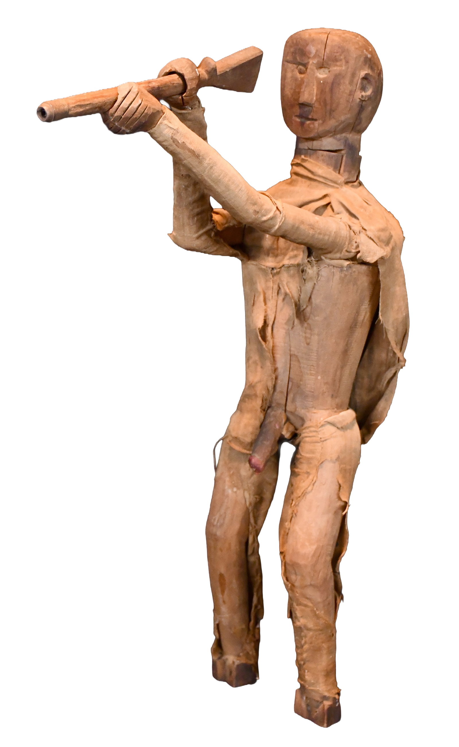 Anonymous Early Hunting Figure with Exposed Genitals.: Anonymous Early Hunting Figure with Exposed Genitals. c. Late 1800s to early 1900s. Carved and stained wood with some original muslin clothing. Loss to front of feet, muslin clothes are tattered, and