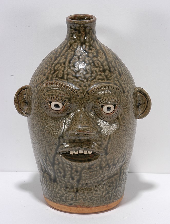 A.G. Meaders. Large Face Jug.: A.G. Meaders. Large Face Jug. c. 1990. Signed. Traditional A.G. green drop tobacco-spit glaze. Mint condition. 11.5”h. Est. $400-600. Ship: $65