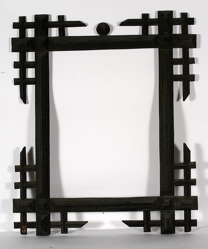 Lg Tramp Art Geometric Corners Frame.: Tramp Art Large Geometric Corners Frame. Chip-carved wood and stain. Very minor loss, otherwise excellent condition. 31” x 36” x 2”. Est. $1,000-2,000. Buyer is responsible for shipping.