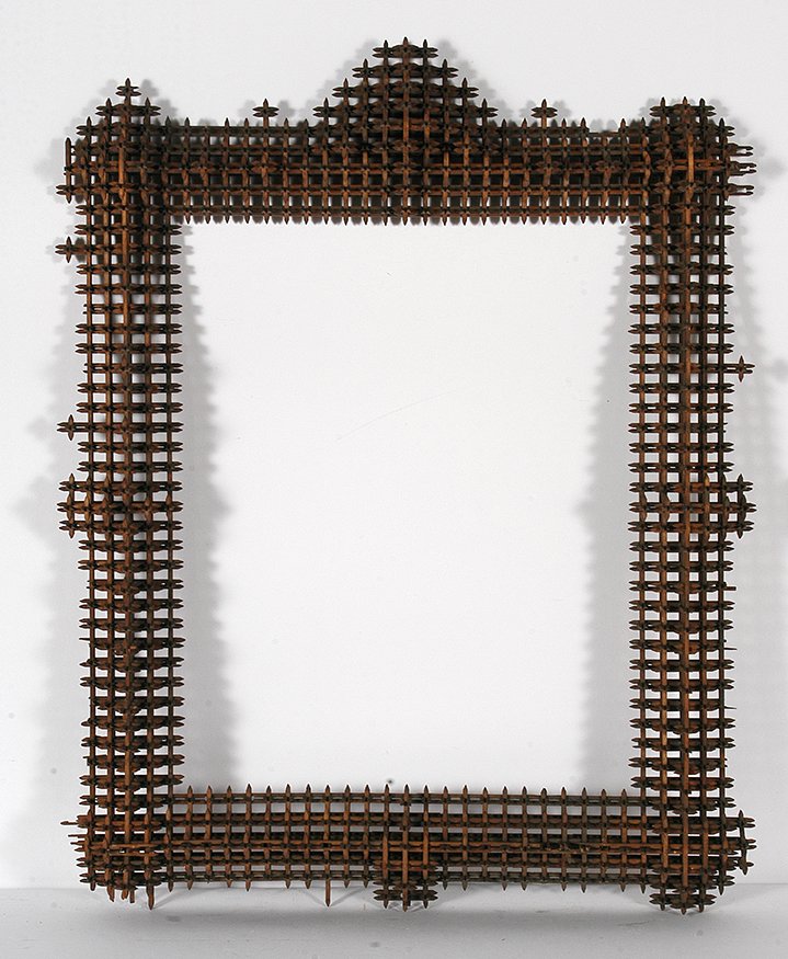 Crown Of Thorn Frame w Pyramid.: Tramp Art Crown Of Thorn Frame With Pyramid On Top. Carved and stained wood. Some missing pieces, otherwise good condition. 24” x 29” x 3”. Est. $300-500. Buyer is responsible for shipping.
